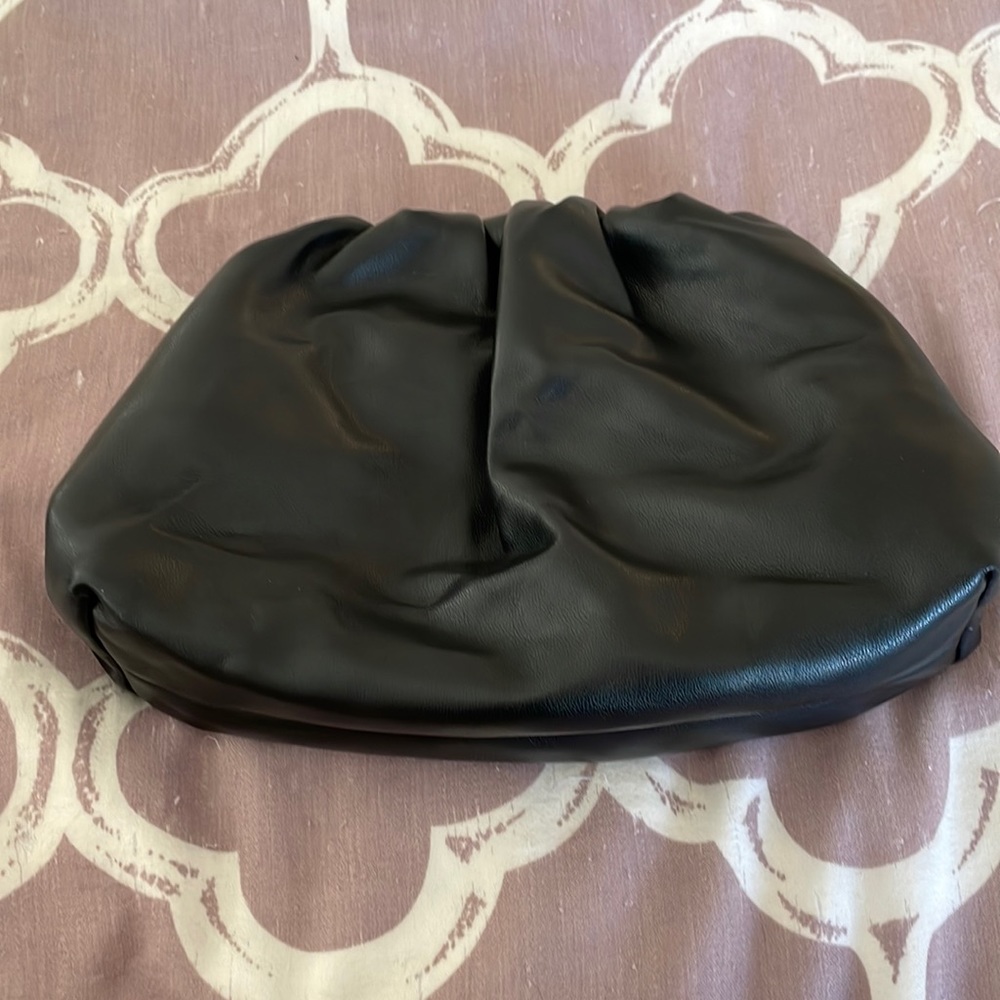 Black handbag with crossbody strap.